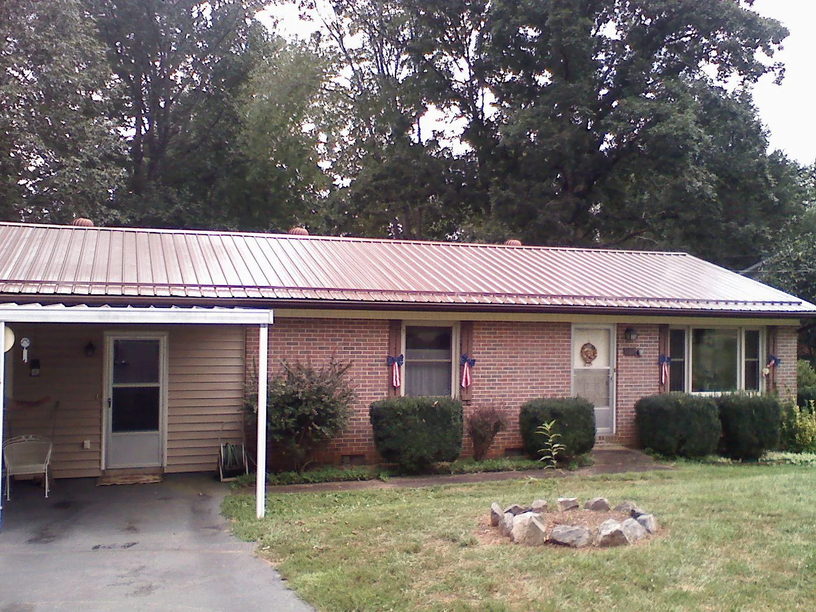 Bronze metal roof and carport on a brick ranch home — Roof Repair work by our crew in West Simsbury